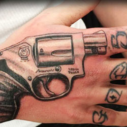 Tattoo of gun on hand