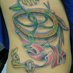 Tattoo of flower key and ribbon