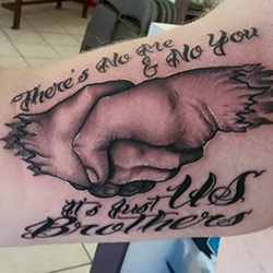 Tattoo of hands and text
