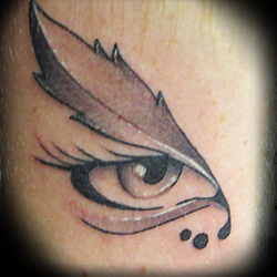 Tattoo of eye and feather